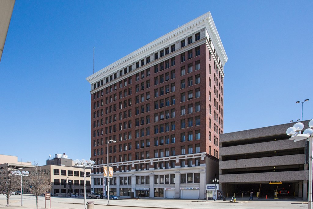 a tall brick building with a blue sky in the background