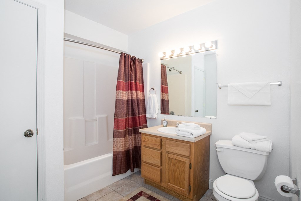 a small bathroom with a shower toilet and sink
