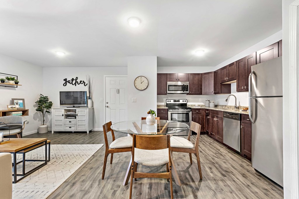 a kitchen with stainless steel appliances and a dining table