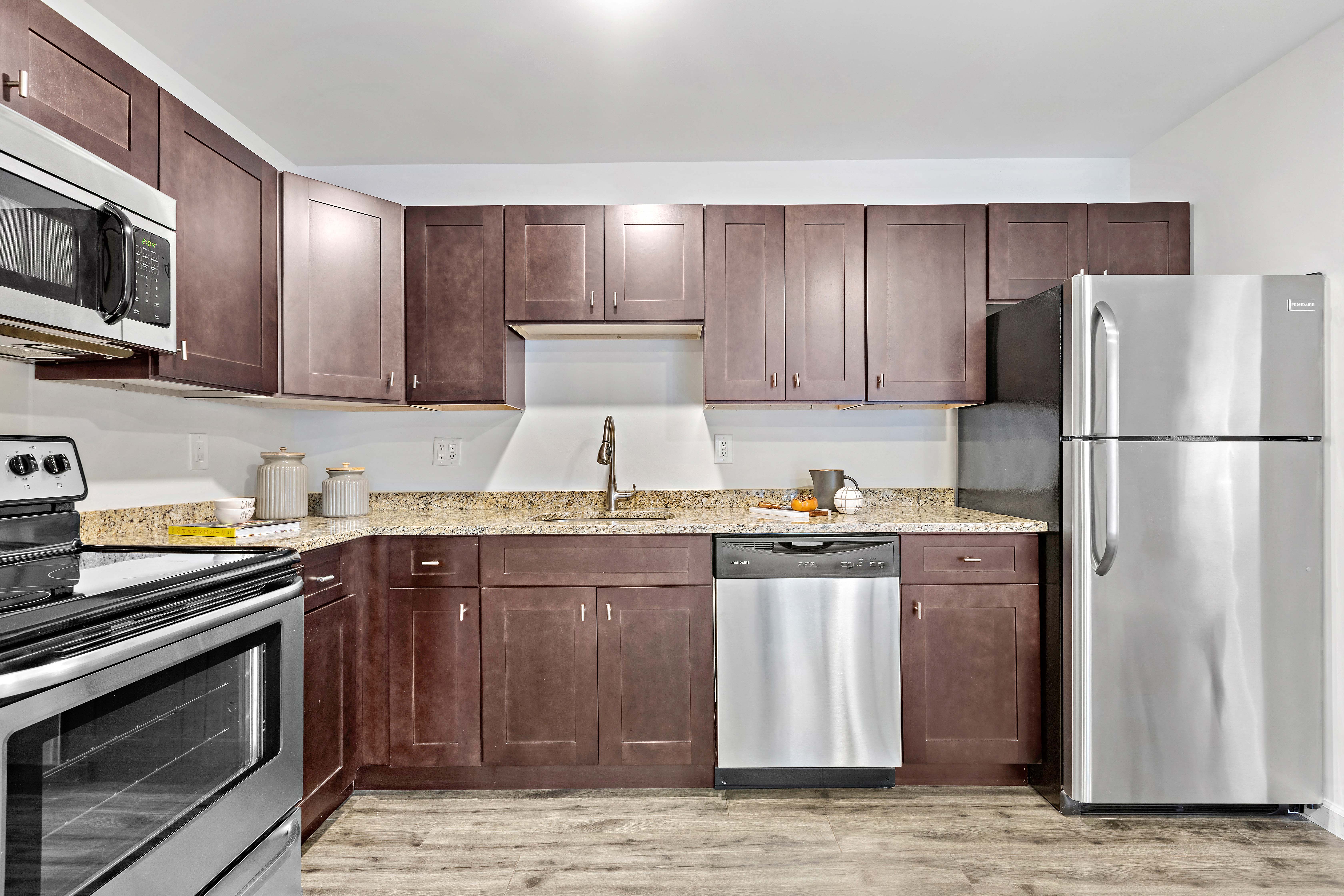 a kitchen with stainless steel appliances and wooden cabinets