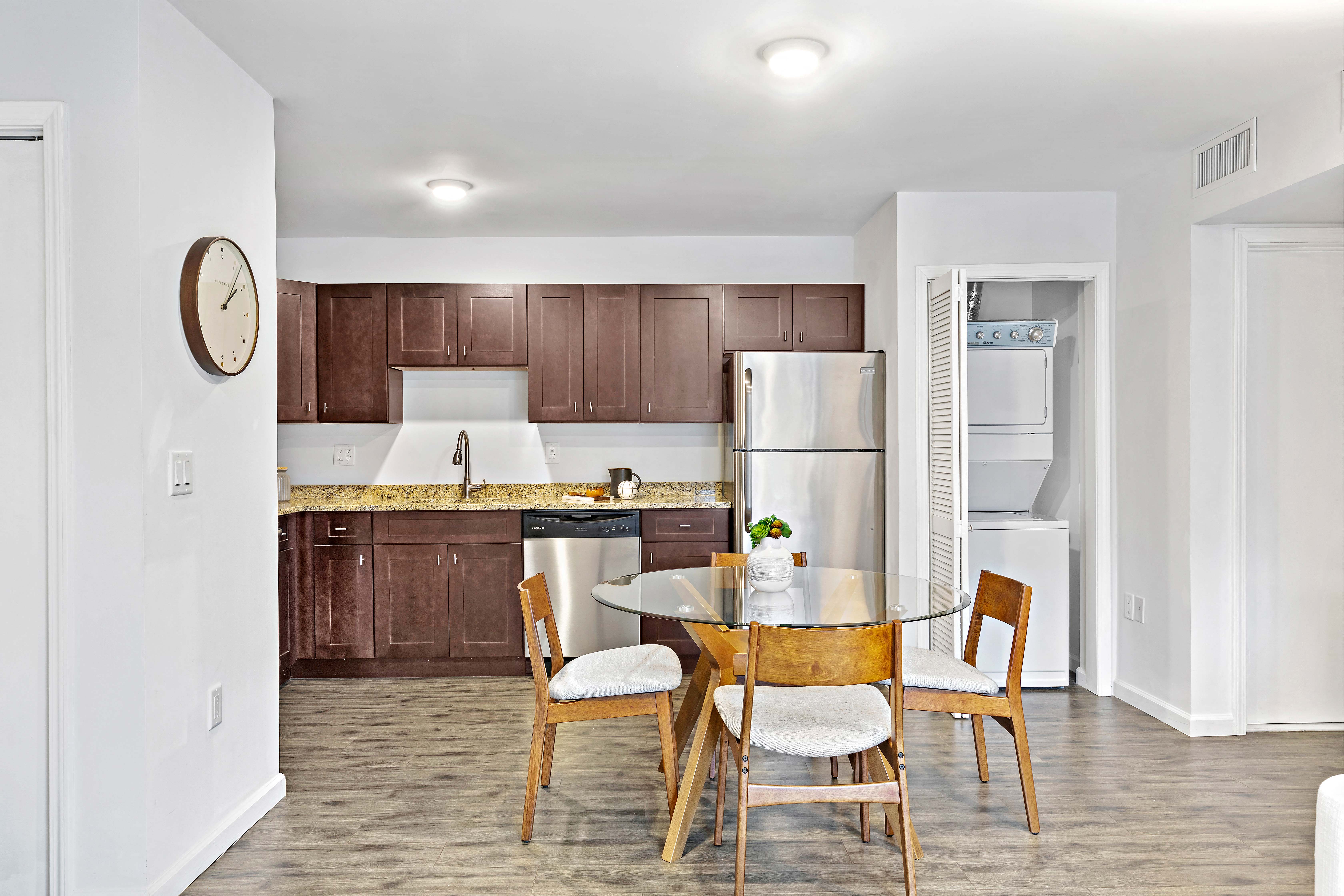 a kitchen with a table and chairs and a refrigerator