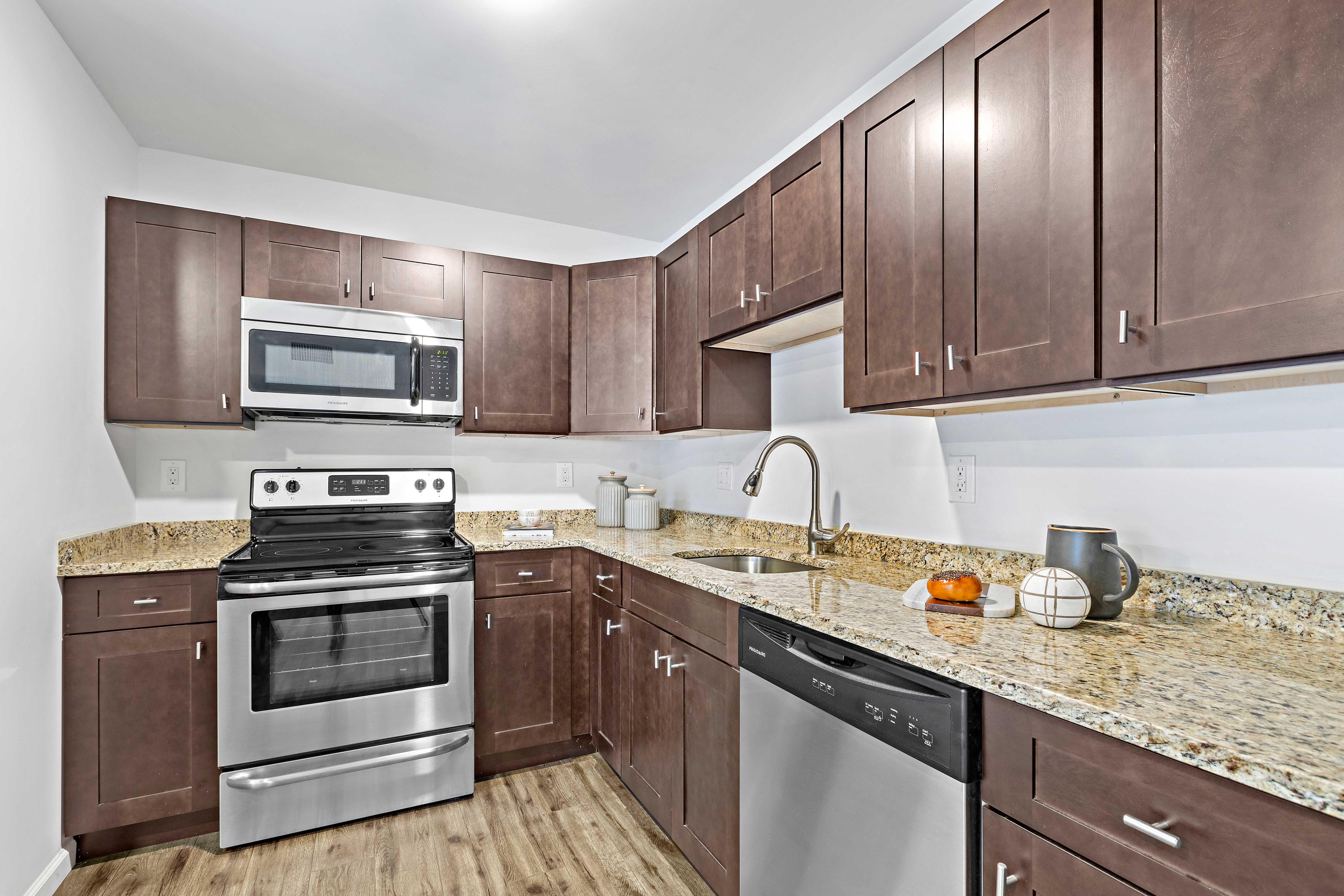 a kitchen with stainless steel appliances and granite counter tops