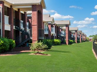 a row of townhomes with green grass in front of them