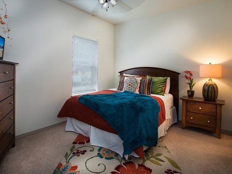 a bedroom with a bed and a dresser and a window