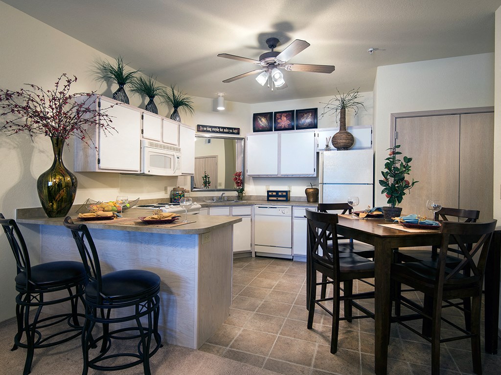 a kitchen and dining area with a table and chairs