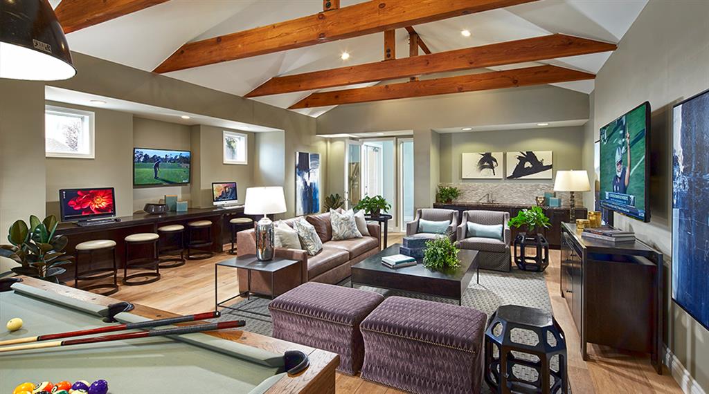 a living room with a pool table and a tv
