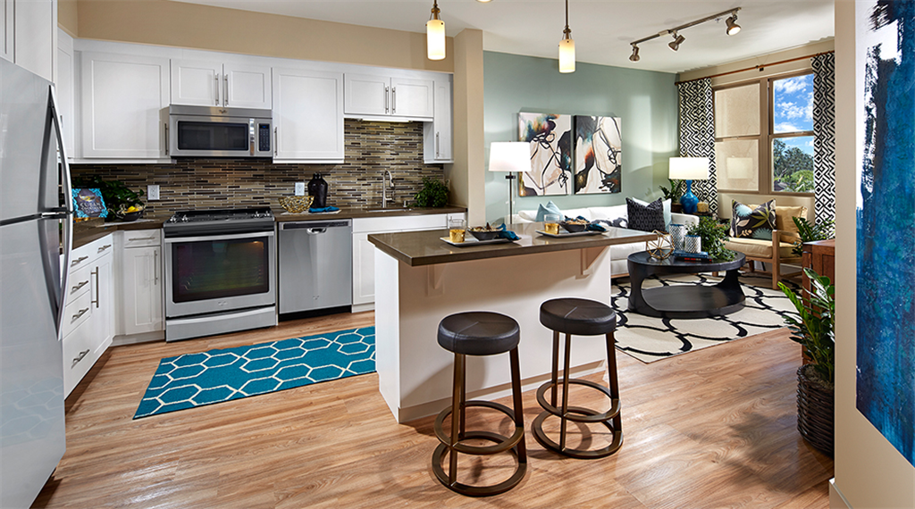 contemporary cabinetry, quartz countertops, glass tile backsplash, stainless steel appliances