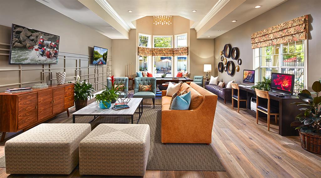 a living room with couches and chairs and a television