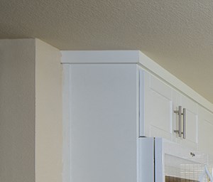 Woodbridge Apartments: Plan 2B Kitchen Model kitchen area with white cabinets at Woodbridge apartments in Irvine.