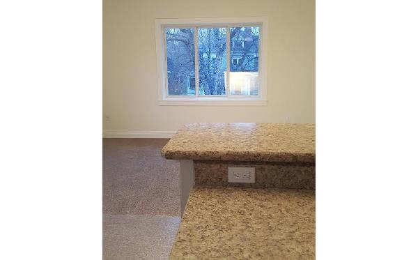 a kitchen with a counter top and a window