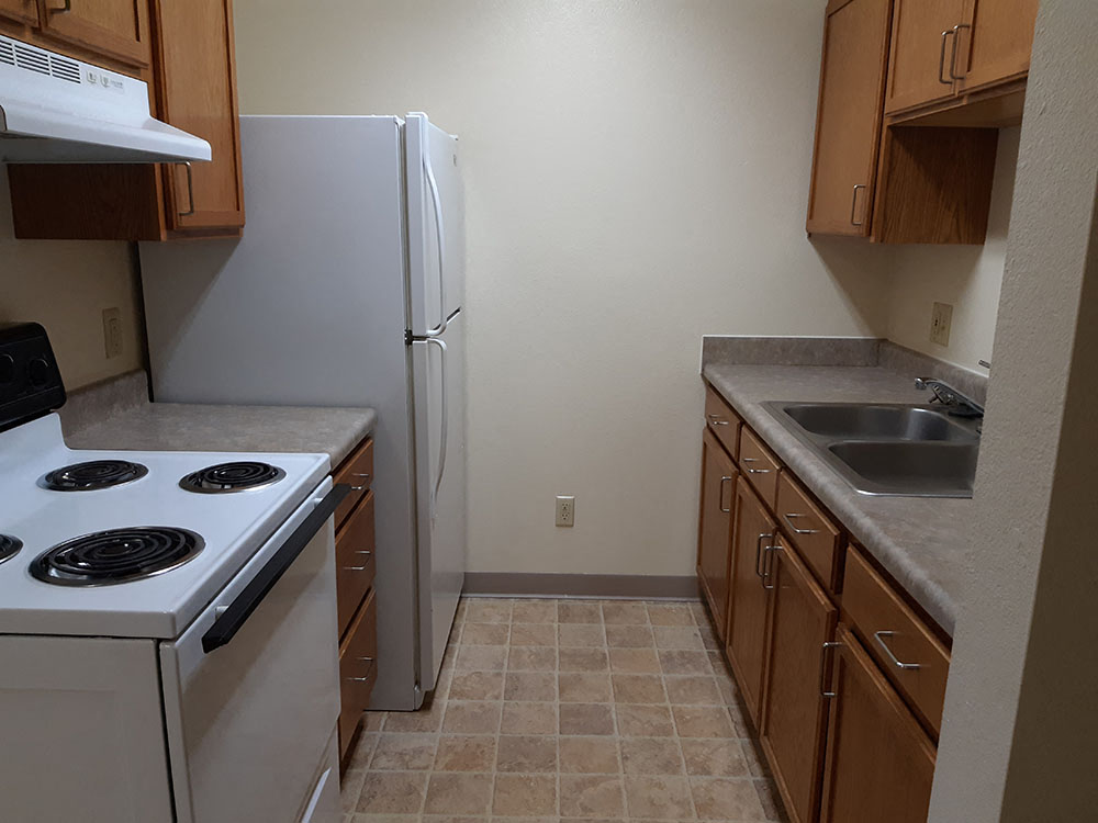 a kitchen with a stove and a refrigerator