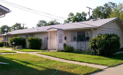 a white house with a yard and a sidewalk