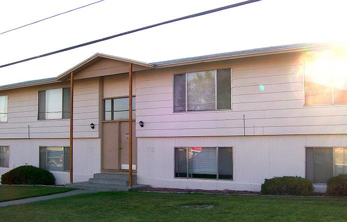 a white house with a yard in front of it