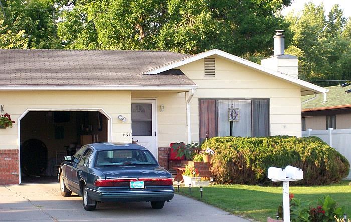 a car parked in a driveway in front of a house