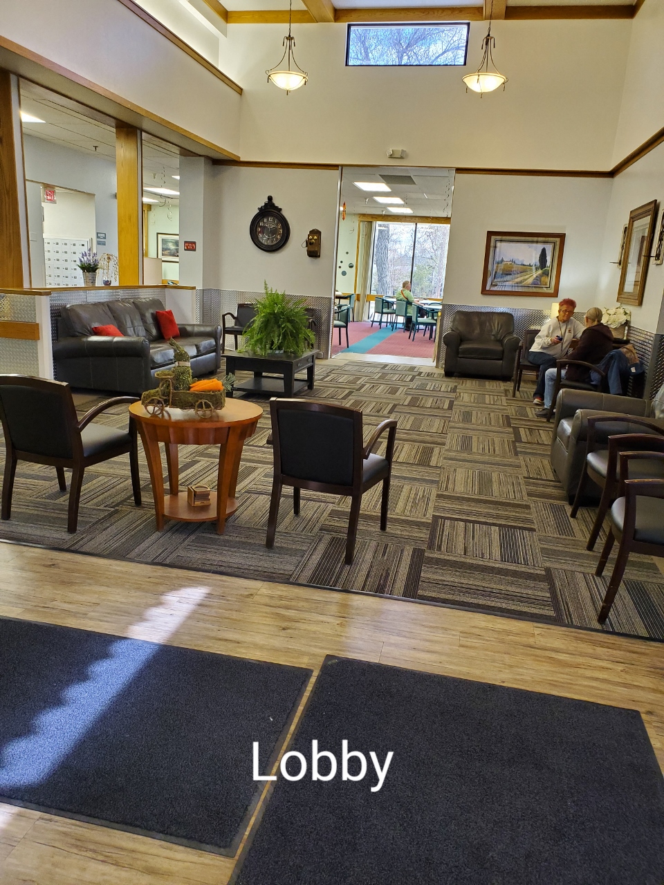 a lobby with couches and chairs and a table