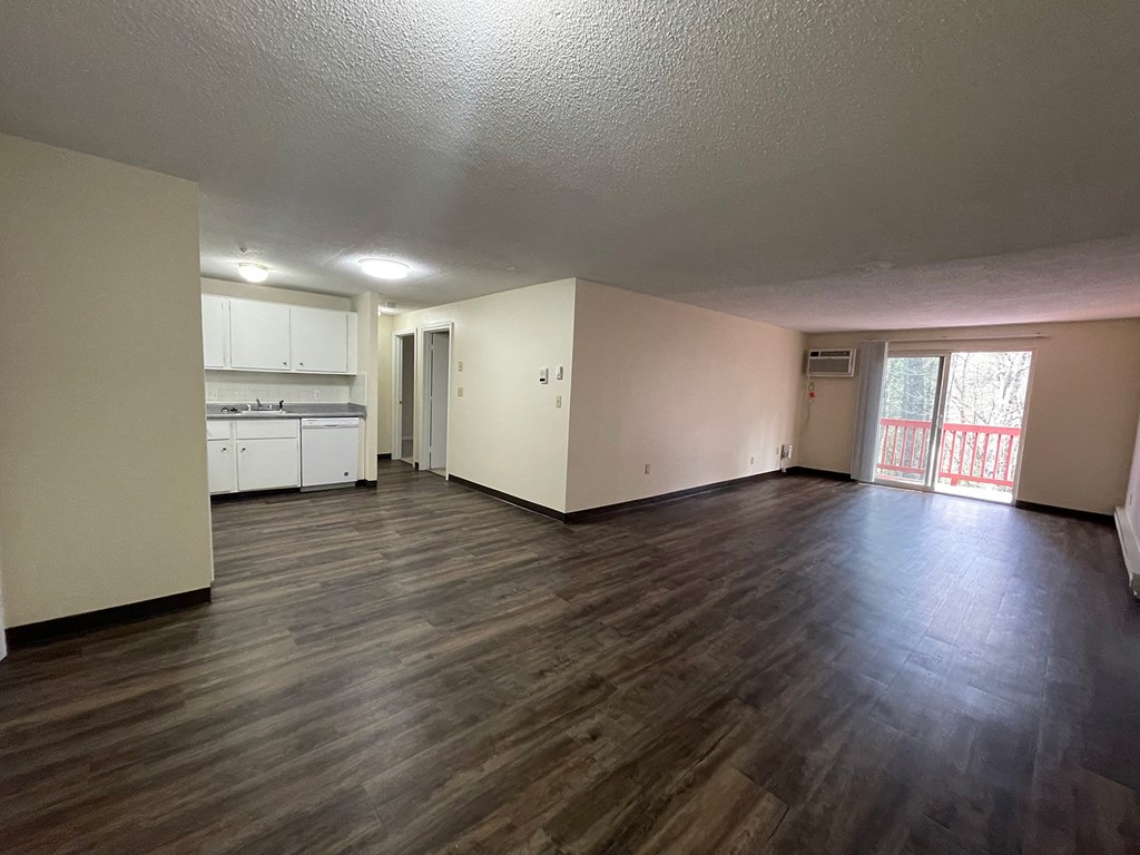 A room with wooden floors and white walls.