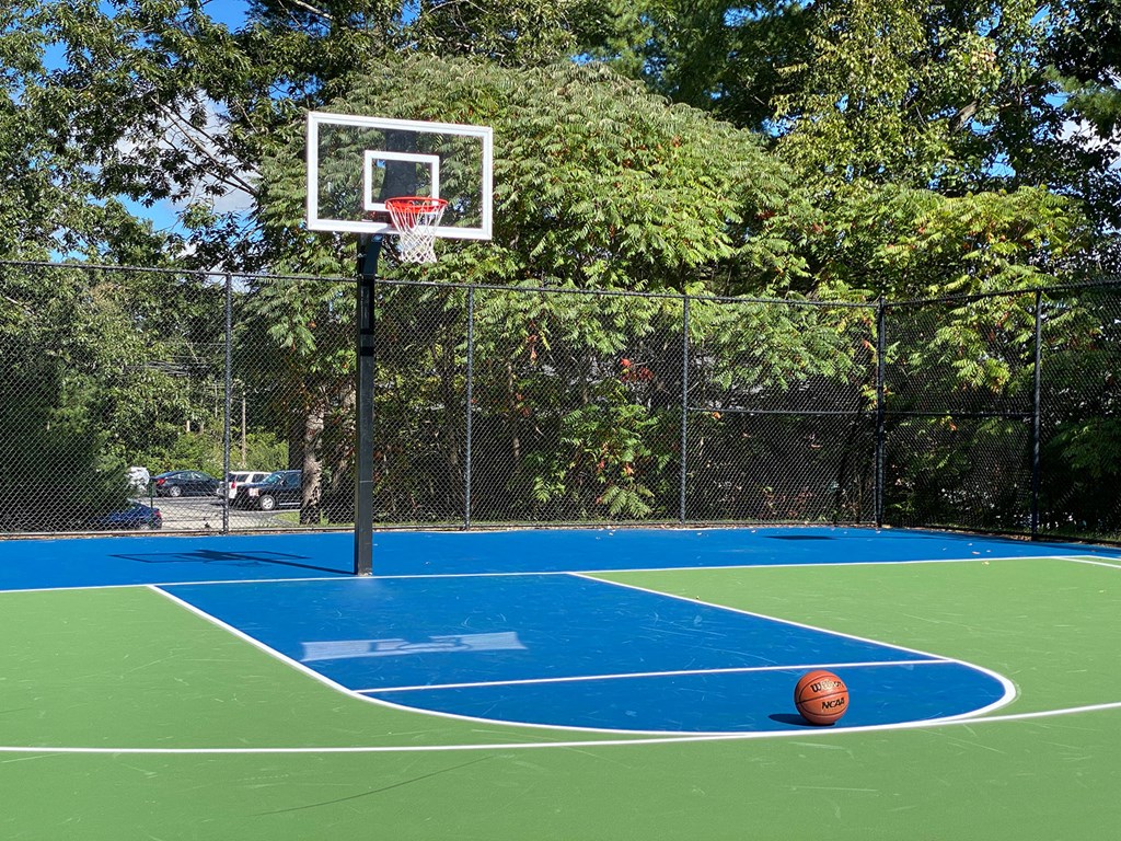 A basketball court with a basketball on the ground.