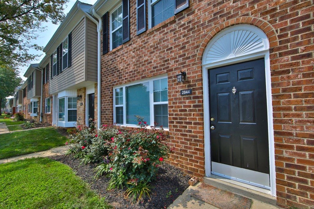a brick apartment building with a black door