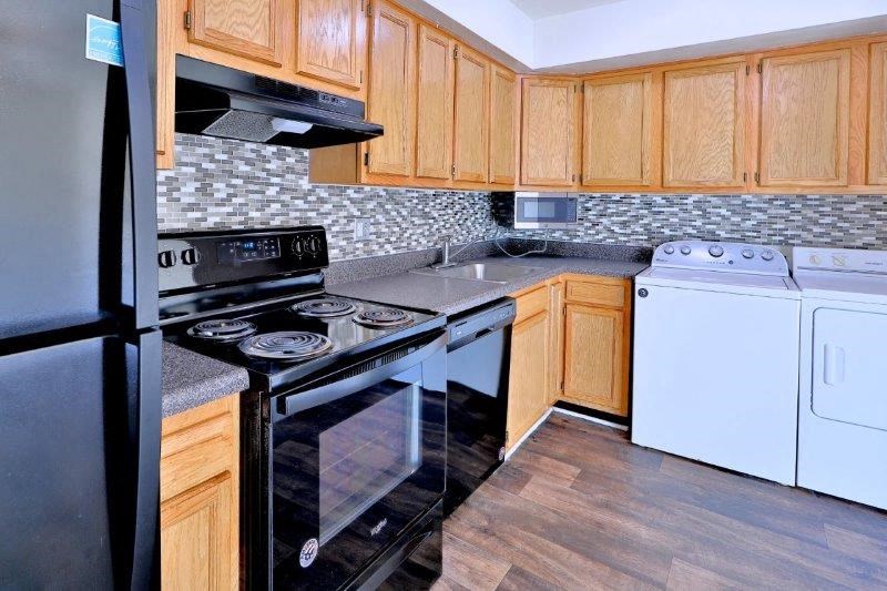 a kitchen with a stove and a refrigerator