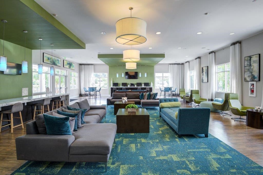 a large living room with couches and chairs and a bar