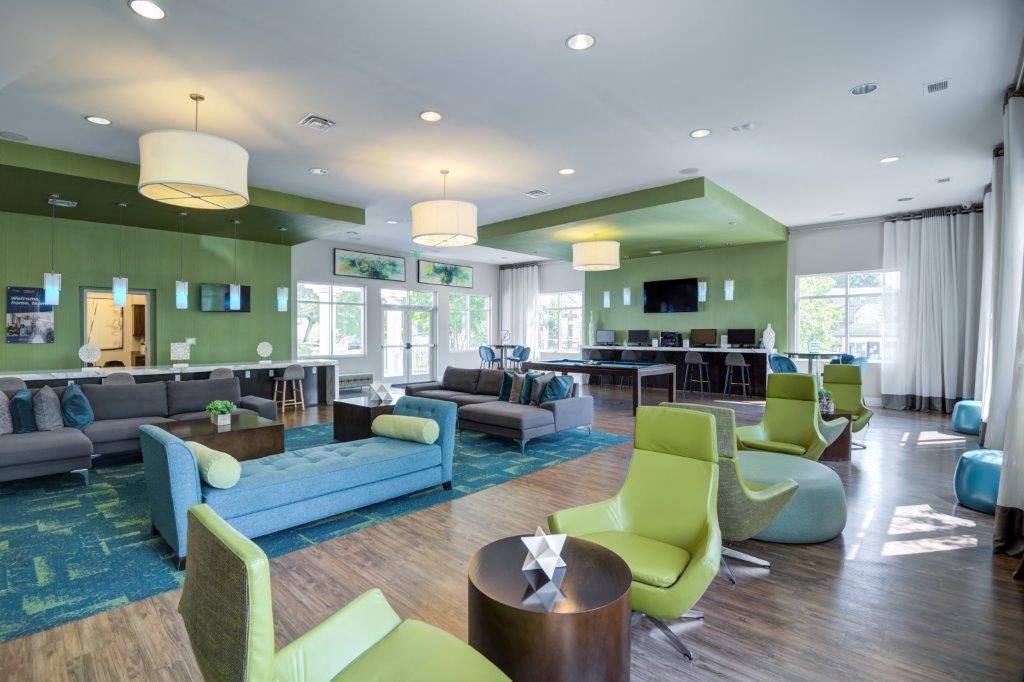 a living room with couches and chairs and a bar