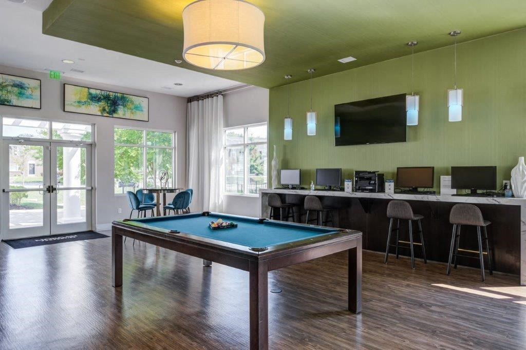 a game room with a pool table and a tv