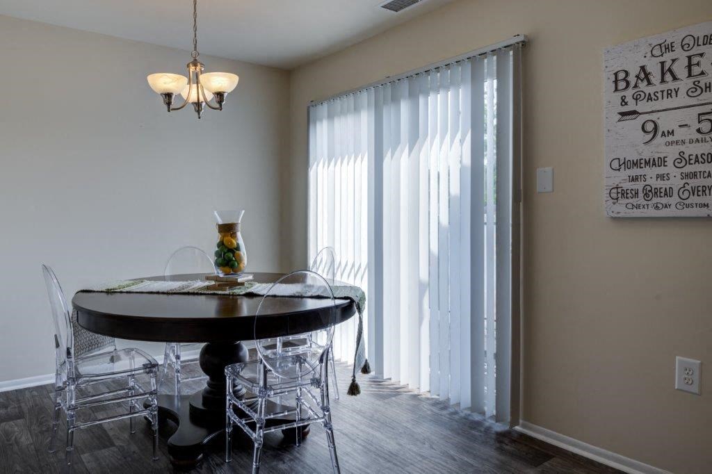 a dining room with a table and chairs and a window