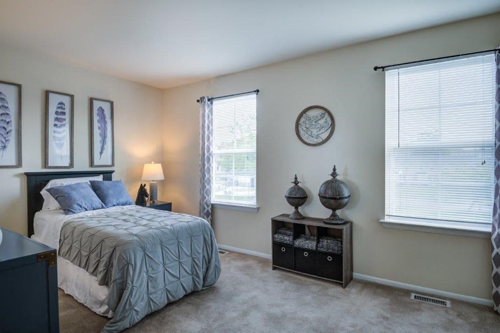 a bedroom with a bed and a dresser