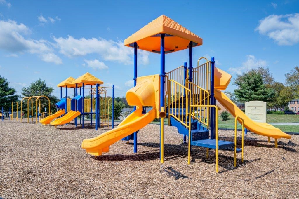 a playground with a yellow swing set
