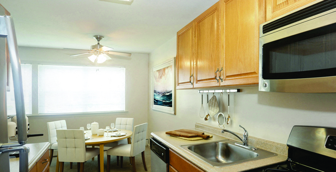 a kitchen and dining room with a sink and a microwave