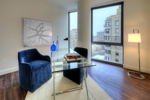 a living room with a glass table and a window