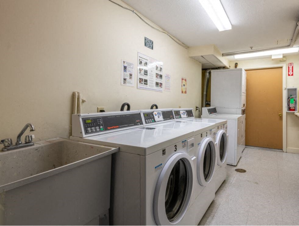 a laundry room with washing machines and a sink