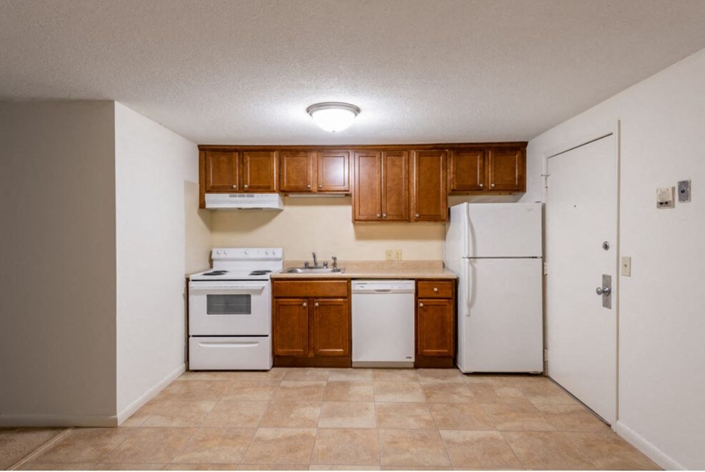 a kitchen with white appliances and wooden cabinets