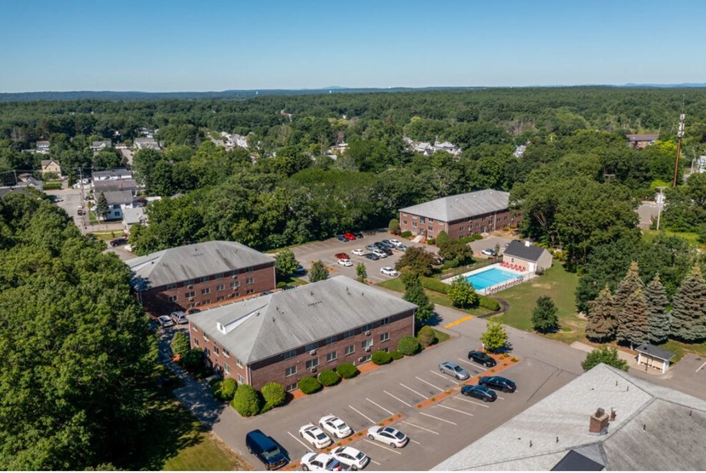 an aerial view of a campus with buildings and a swimming pool