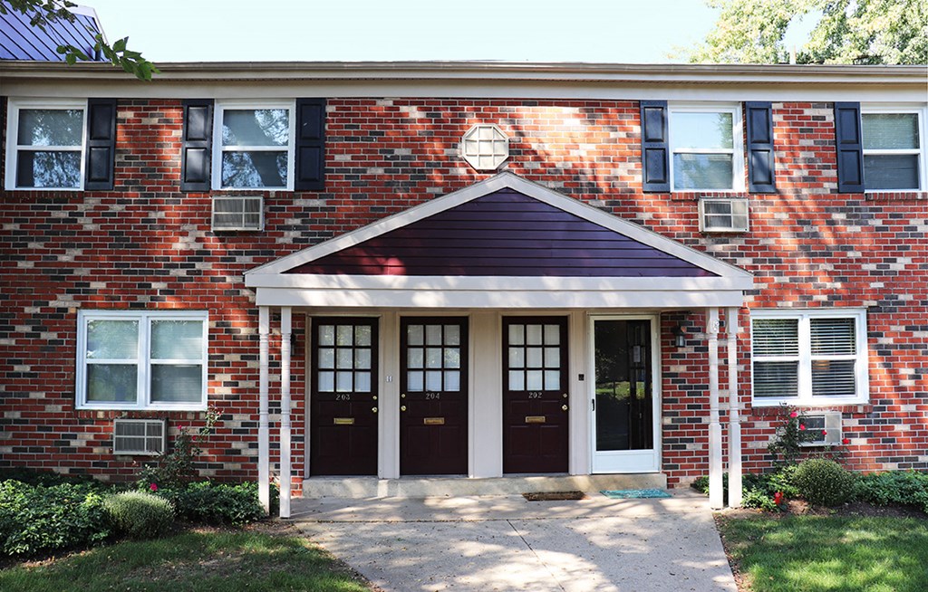 a brick building with two doors and a porch