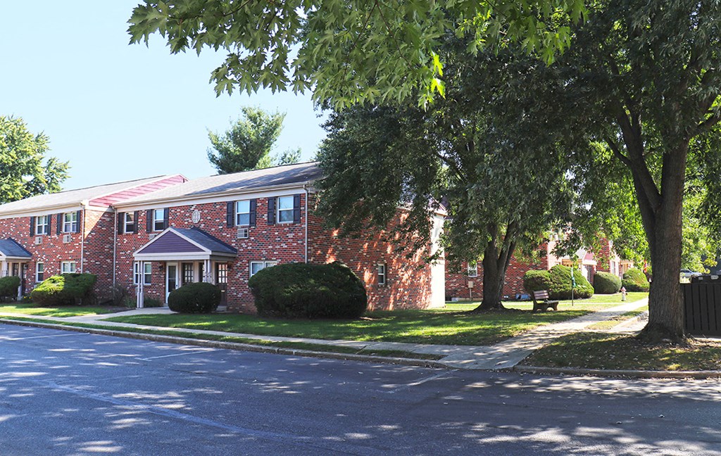 a red brick building with trees in front of it