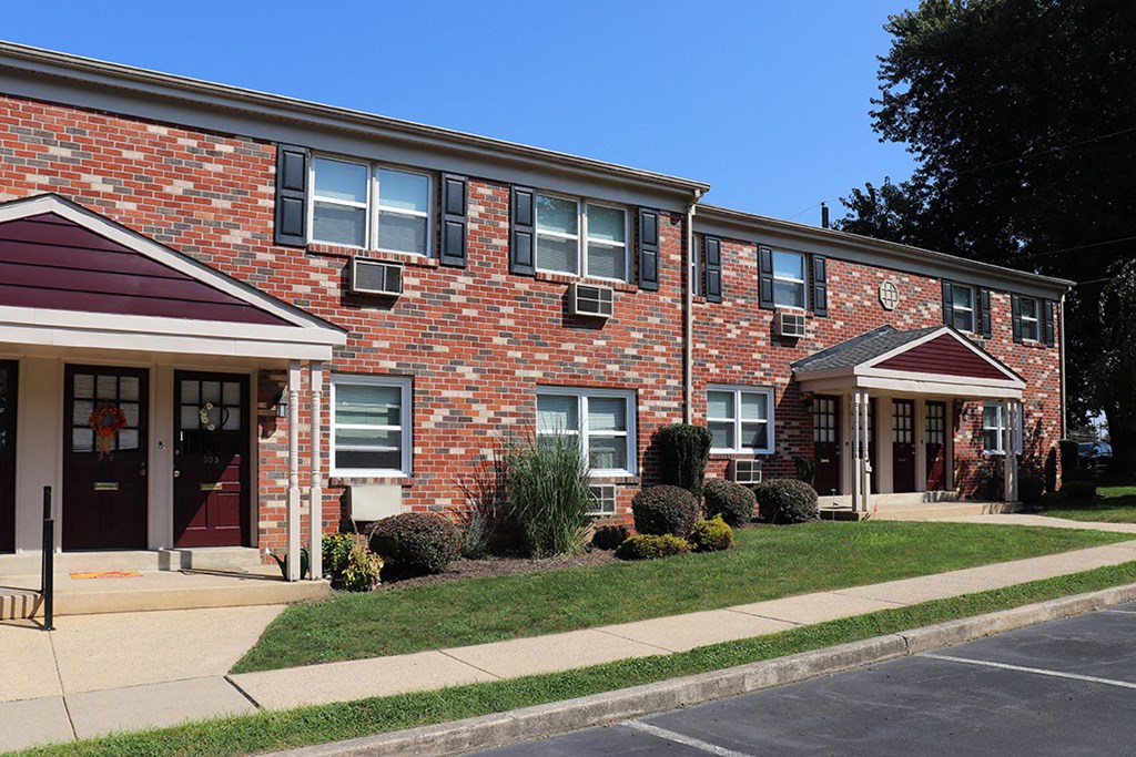 a brick building with a sidewalk in front of it