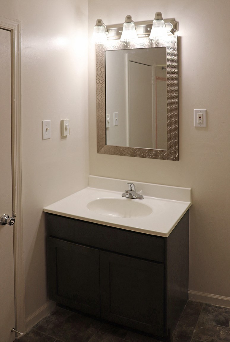 a small bathroom with a sink and a mirror