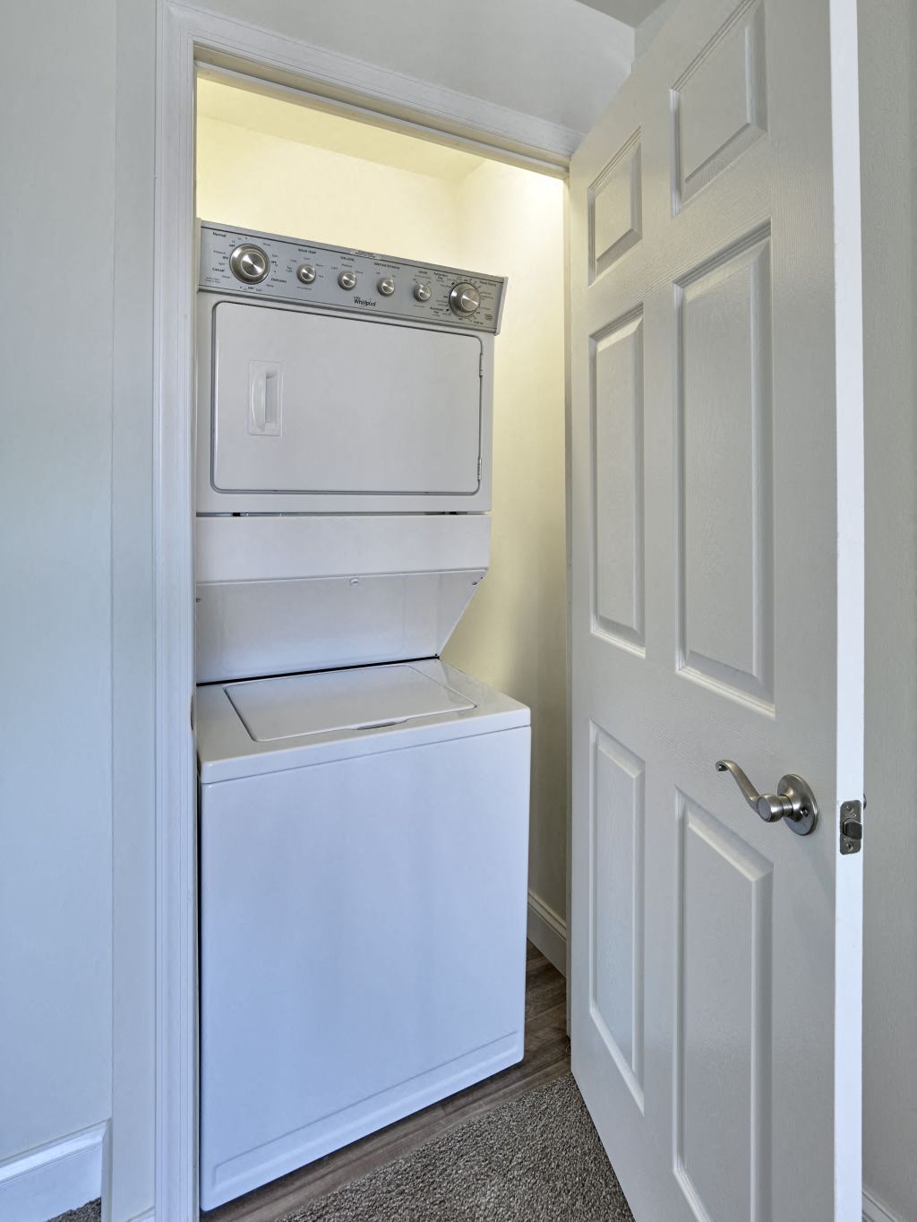 a white washer and dryer in a room with a white door