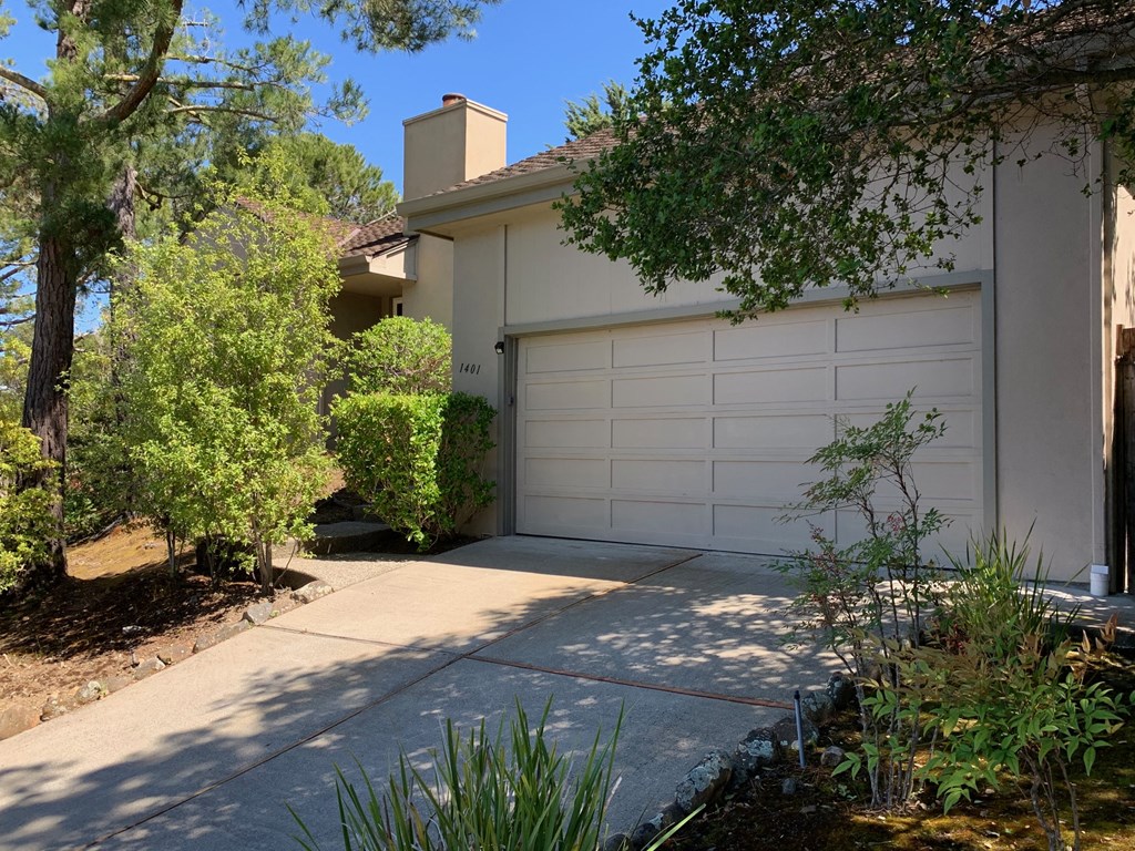 a white garage door in front of a house