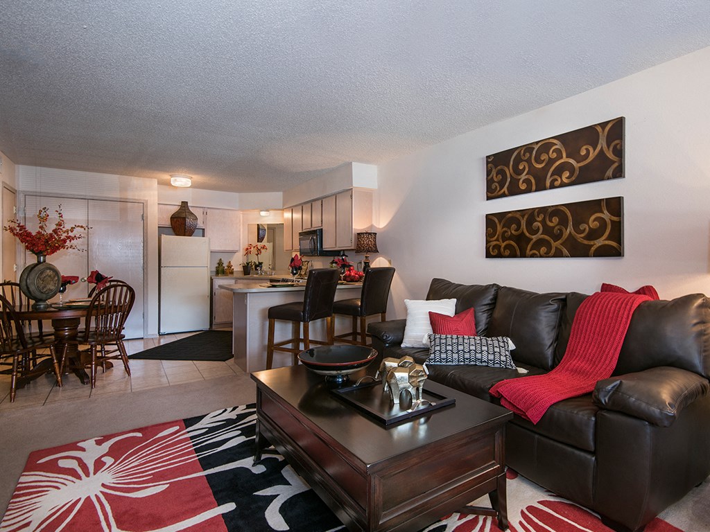 an open living room and kitchen with a couch and a table