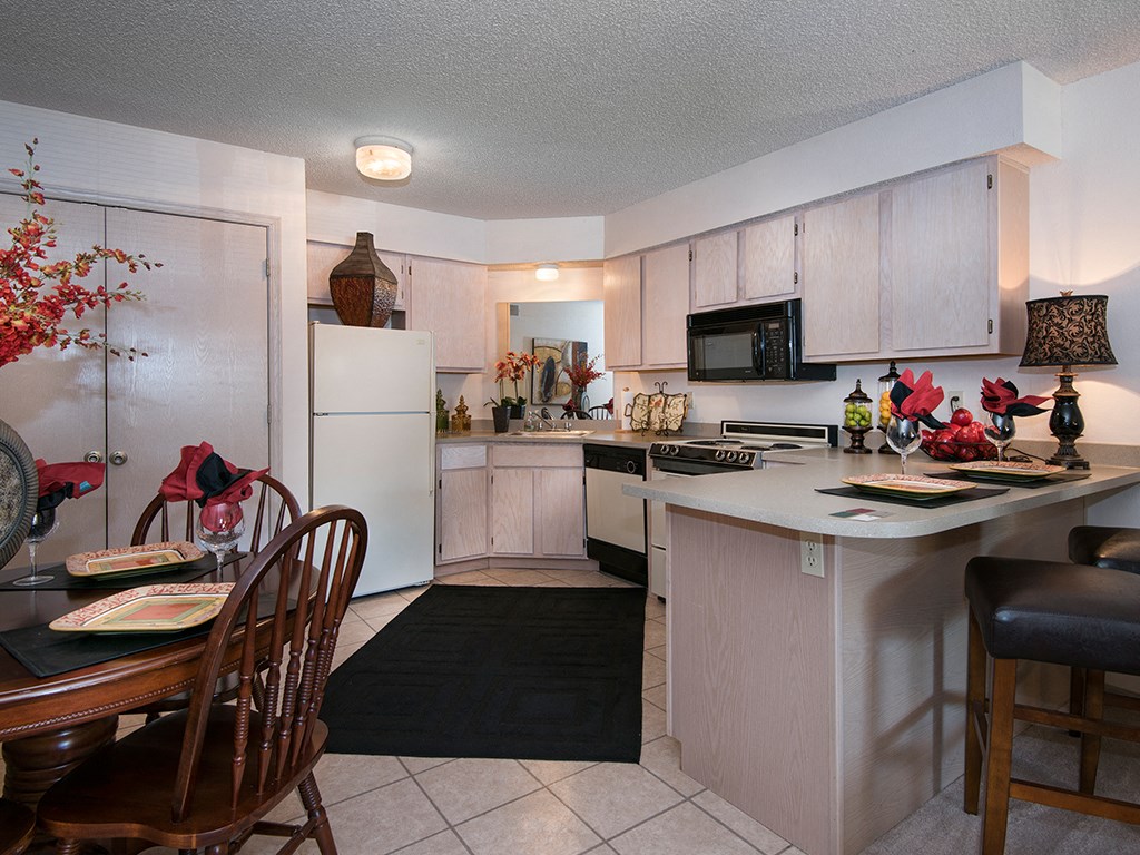a kitchen and dining room with a table and chairs