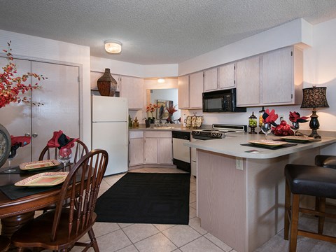 a kitchen and dining room with a table and chairs
