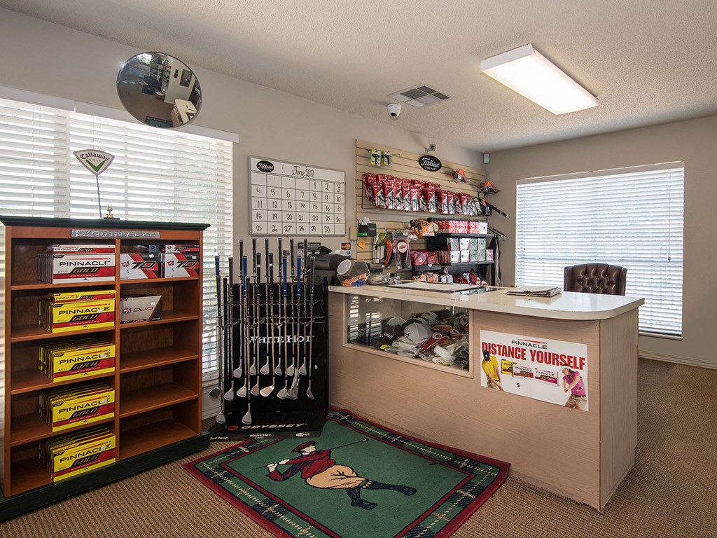 a room with a counter with baseball bats and other items
