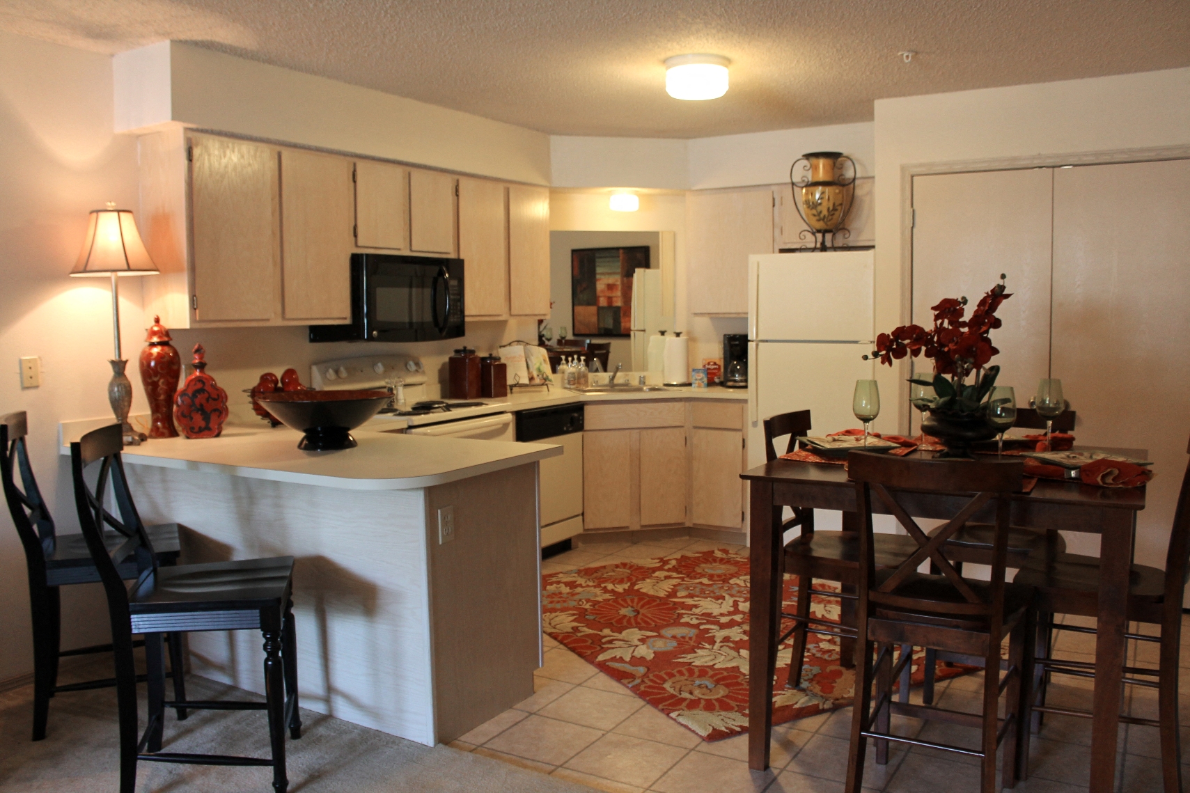 a kitchen and dining room with a table and chairs