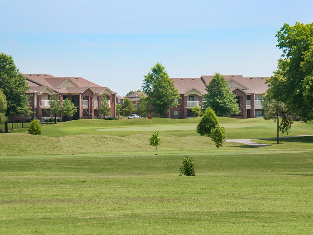 a golf course with houses in the background