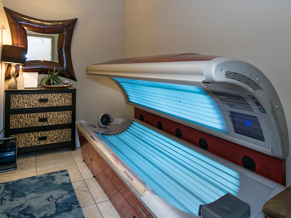 a spa room with a massage bed and a surfboard