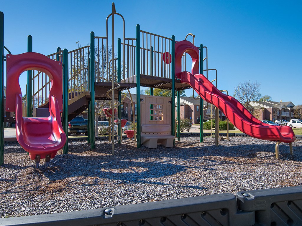 a playground with two childrens slides and a