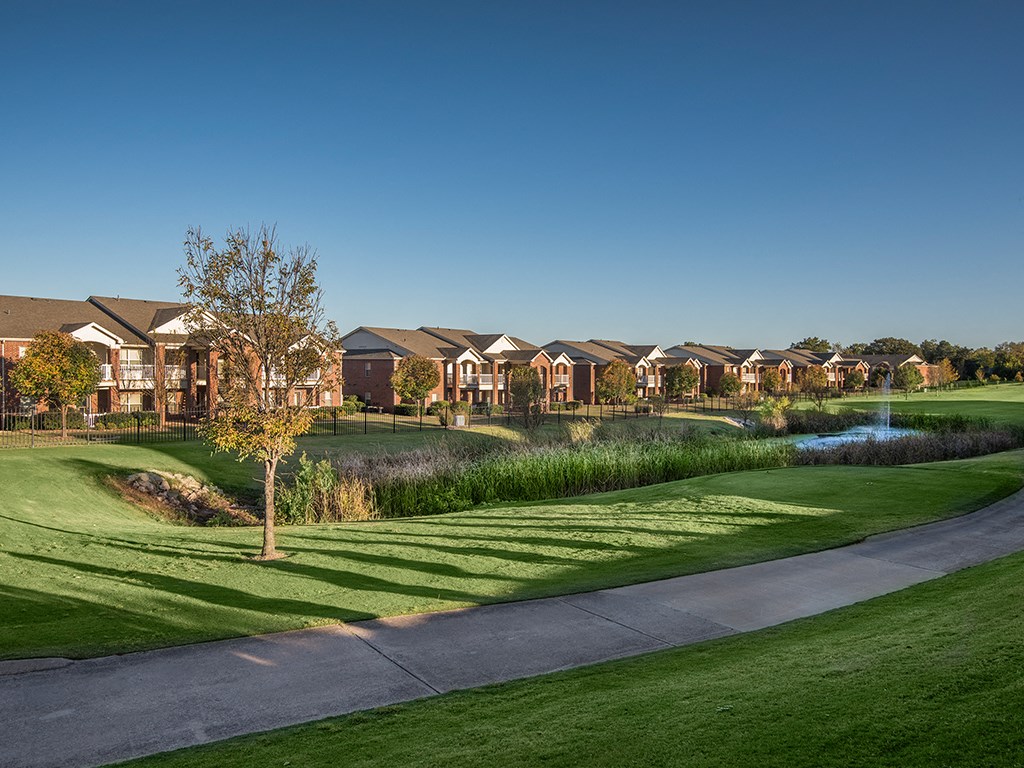 a row of houses on the side of a golf course
