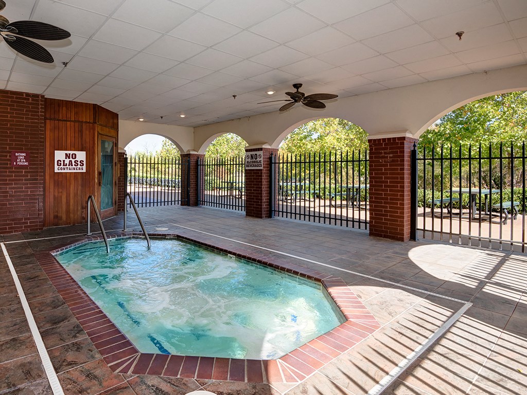 a spa with a pool in a house with a fence